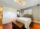 Cozy bedroom featuring hardwood floors, a comfortable bed, closet, and bright natural light at 5127 Leeward Way, Orlando, FL 32809