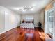 Bedroom featuring hardwood floors, a bed, lighting, bi-fold closet doors, and a window at 5127 Leeward Way, Orlando, FL 32809