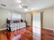 Comfortable bedroom featuring hardwood floors, a day bed, and bright natural light at 5127 Leeward Way, Orlando, FL 32809