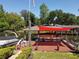 Picturesque boat dock with boat lift, patio furniture, and canopy offering sun protection at 5127 Leeward Way, Orlando, FL 32809