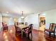 Open-concept dining room with hardwood floors, decorative lighting, and seamless flow to the kitchen at 5127 Leeward Way, Orlando, FL 32809