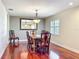Cozy dining room with hardwood floors, elegant furniture, and a large mirror at 5127 Leeward Way, Orlando, FL 32809