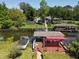 Aerial view of private dock with multiple boat houses and direct lake access at 5127 Leeward Way, Orlando, FL 32809