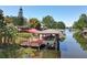 Lakefront dock with boat lifts and outdoor seating on a charming waterway at 5127 Leeward Way, Orlando, FL 32809