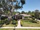 Charming brick home with mature landscaping, manicured lawn, and a welcoming brick pathway at 5127 Leeward Way, Orlando, FL 32809