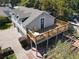 Aerial view of the house showcasing the upstairs deck and beautiful landscaping at 5127 Leeward Way, Orlando, FL 32809