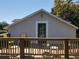 Upstairs exterior view of home with wooden deck and plenty of outdoor seating at 5127 Leeward Way, Orlando, FL 32809