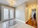 Bright foyer featuring tile flooring, a decorative light fixture and view down a hardwood hall at 5127 Leeward Way, Orlando, FL 32809
