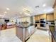 Bright open kitchen with island, granite countertops, stainless appliances, and ample cabinet storage at 5127 Leeward Way, Orlando, FL 32809