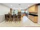 Spacious kitchen featuring an island with bar seating, granite countertops, and stainless steel appliances at 5127 Leeward Way, Orlando, FL 32809