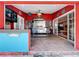 Outdoor kitchen featuring a stainless steel range, island prep space, and a convenient pass-through to the dining area at 5127 Leeward Way, Orlando, FL 32809