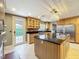 Modern kitchen with wood cabinets, granite countertops, stainless steel appliances, and an island at 5127 Leeward Way, Orlando, FL 32809