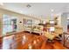 Spacious living area showcasing hardwood floors, natural light, and an open layout to the kitchen at 5127 Leeward Way, Orlando, FL 32809