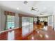 Spacious living room with hardwood floors and view of the screened pool at 5127 Leeward Way, Orlando, FL 32809