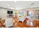 Open living room with hardwood floors, recessed lighting, and views of the backyard pool at 5127 Leeward Way, Orlando, FL 32809