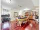 Large room with hardwood floors, pool table, pinball machine, and bar-height dining table at 5127 Leeward Way, Orlando, FL 32809