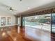 Hardwood floors in living room with large sliding doors overlooking a screened pool at 5127 Leeward Way, Orlando, FL 32809
