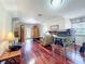 Bright living room with hardwood floors, neutral paint, and a door to the outdoor deck at 5127 Leeward Way, Orlando, FL 32809