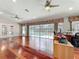 Bright living room with hardwood floors and view of the screened pool at 5127 Leeward Way, Orlando, FL 32809