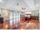 Spacious main bedroom featuring hardwood floors, a ceiling fan, french doors and mirrors at 5127 Leeward Way, Orlando, FL 32809
