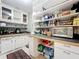 Well-organized pantry with ample shelving and counter space for storage and food preparation at 5127 Leeward Way, Orlando, FL 32809