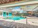 A screened-in pool and spa is perfect for outdoor enjoyment and relaxation, surrounded by lush landscaping at 5127 Leeward Way, Orlando, FL 32809