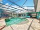 A screened-in pool area offers ample space for swimming, lounging, and outdoor enjoyment with serene backyard views at 5127 Leeward Way, Orlando, FL 32809