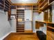 Large walk-in closet with custom wood shelving and hardwood floors at 5127 Leeward Way, Orlando, FL 32809