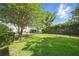 Spacious backyard featuring lush green grass and a black metal fence, ideal for outdoor activities at 5262 Baskin St, Orlando, FL 32814