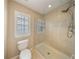 Bright bathroom with glass shower, window, and neutral tiling for a spa-like feel at 5262 Baskin St, Orlando, FL 32814
