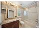 Bathroom featuring granite counters, stylish vanity, and shower-tub combination at 5262 Baskin St, Orlando, FL 32814