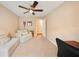 Bedroom with a ceiling fan, neutral walls, and comfortable seating area at 5262 Baskin St, Orlando, FL 32814