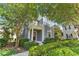 Inviting two-story home showcasing a columned porch, balcony, and lush landscaping at 5262 Baskin St, Orlando, FL 32814