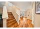 Stylish foyer with hardwood floors, a staircase, and an open view to the dining room at 5262 Baskin St, Orlando, FL 32814