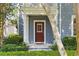 Charming home featuring a red front door, manicured landscaping, and a welcoming entrance at 5262 Baskin St, Orlando, FL 32814
