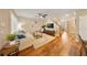 Bright living room with hardwood floors, comfortable seating, and view into dining area at 5262 Baskin St, Orlando, FL 32814