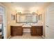 Ensuite main bathroom boasts double sinks, granite counters, and lots of lighting at 5262 Baskin St, Orlando, FL 32814