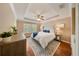 Main bedroom with tray ceiling, fan, hardwood floors and lots of light at 5262 Baskin St, Orlando, FL 32814