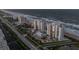 Aerial view of condo community featuring manicured lawns, a tennis court, and ocean access at 5275 S Atlantic Ave # 506, New Smyrna Beach, FL 32169