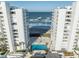 Stunning aerial view of luxury condos featuring a swimming pool and access to a beautiful beach at 5275 S Atlantic Ave # 506, New Smyrna Beach, FL 32169