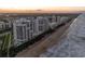 Wide aerial view of high-rise condos along the ocean with panoramic views of the landscape at 5275 S Atlantic Ave # 506, New Smyrna Beach, FL 32169