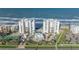 Aerial view of beachfront condos with pool and tennis court at 5275 S Atlantic Ave # 506, New Smyrna Beach, FL 32169