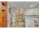 Bathroom featuring a glass enclosed shower, toilet and vanity with a mirror at 5275 S Atlantic Ave # 506, New Smyrna Beach, FL 32169