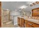 Bathroom with double sink vanity, walk-in shower, and decorative tile at 5275 S Atlantic Ave # 506, New Smyrna Beach, FL 32169