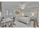 Comfortable bedroom space with ceiling fan, desk, and neutral decor at 5275 S Atlantic Ave # 506, New Smyrna Beach, FL 32169