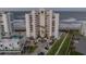 Gorgeous exterior of a beachfront condo building with lush landscaping and private parking at 5275 S Atlantic Ave # 506, New Smyrna Beach, FL 32169