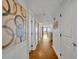 Bright hallway with wood-look flooring and artwork leading to the living space with beautiful ocean views at 5275 S Atlantic Ave # 506, New Smyrna Beach, FL 32169