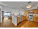 Open-concept kitchen with stainless steel appliances, hardwood flooring, and a view of the living area at 5275 S Atlantic Ave # 506, New Smyrna Beach, FL 32169