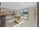 Bright kitchen with stainless steel appliances, island and a sliding door to a patio at 5275 S Atlantic Ave # 506, New Smyrna Beach, FL 32169