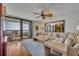 Relaxing living room with comfortable seating, a ceiling fan, and sliding doors to a private balcony at 5275 S Atlantic Ave # 506, New Smyrna Beach, FL 32169